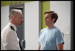 Mark Bonnar as Officer Meekie alongside Kevin Bishop as Fletch